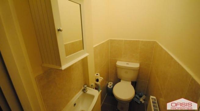 Compact, neatly presented bathroom with a toile...