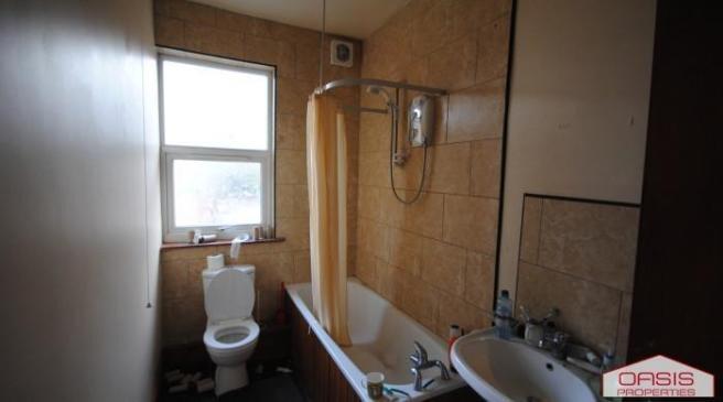 Simple bathroom with bathtub, wall-mounted show...