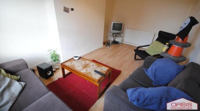 Bright, simply furnished living room with two s...