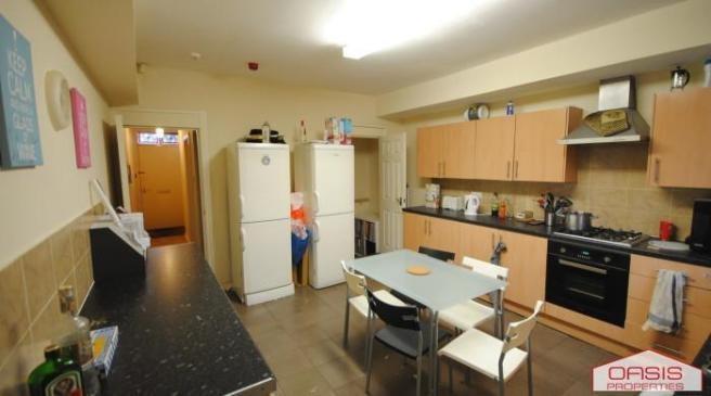Bright, modern kitchen with ample storage and w...