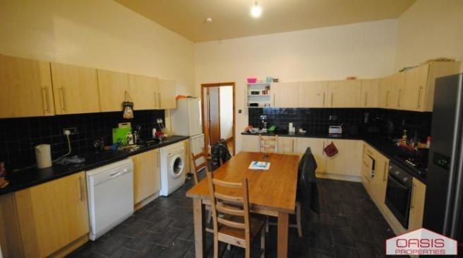 Bright, well-equipped kitchen with abundant cab...