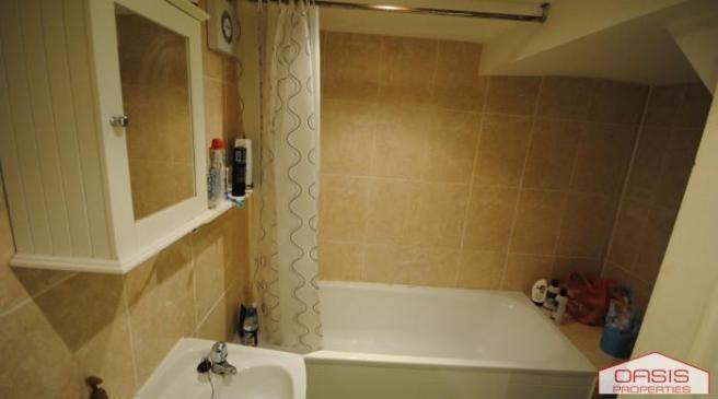 Well-presented tiled bathroom featuring a batht...