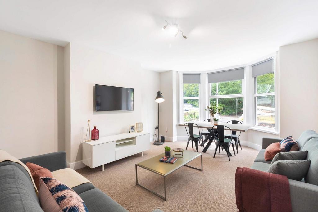 Bright, modern living room with large bay windo...