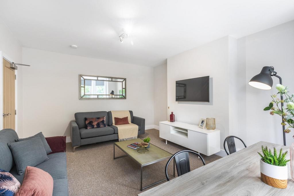 Bright, modern living room with comfortable sof...