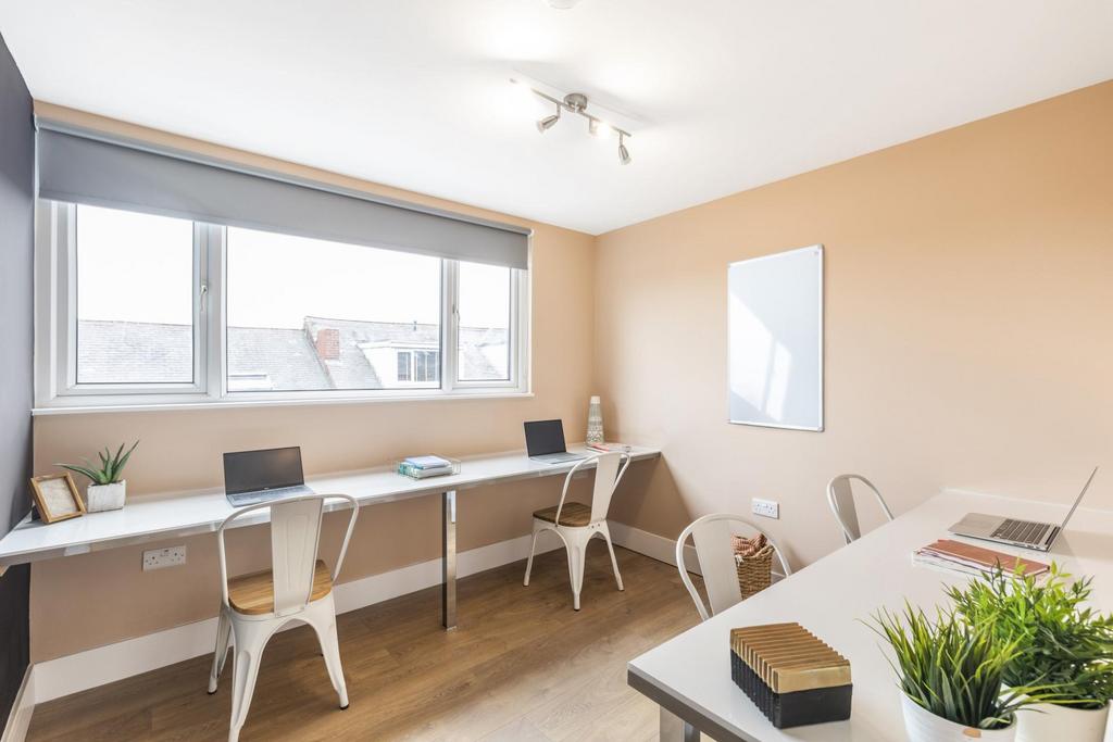 Bright shared study space with long built-in de...