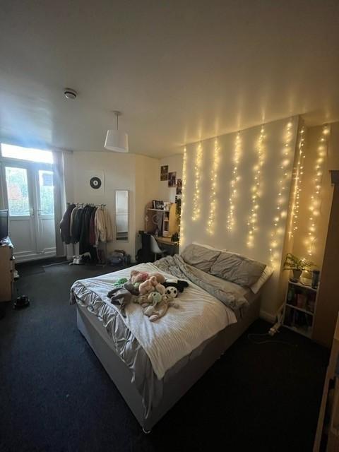 Comfortable double bedroom with a made bed, coz...