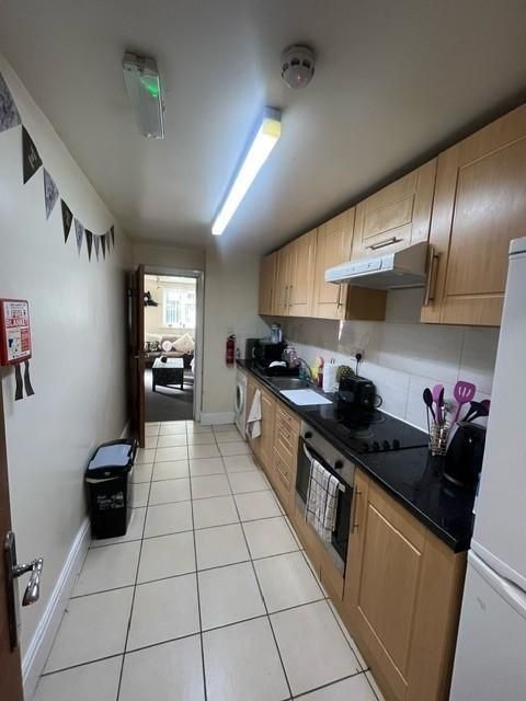 Bright galley kitchen with wood-effect cabinetr...
