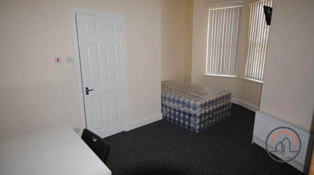 Simple, tidy single bedroom with a window provi...
