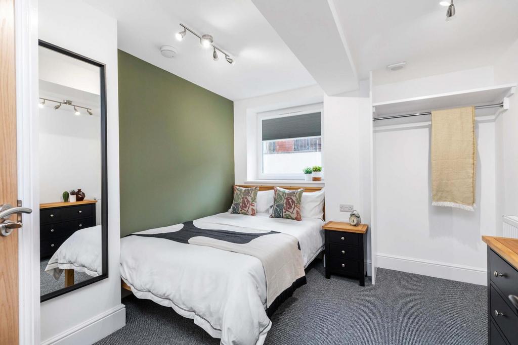 Bright, neatly presented bedroom with a double ...