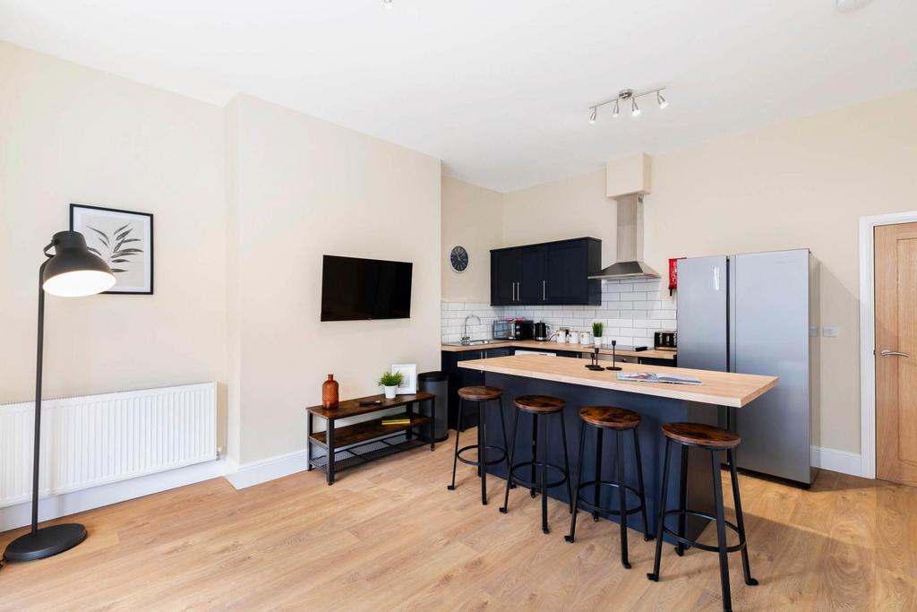 Bright open-plan kitchen with a long island bre...