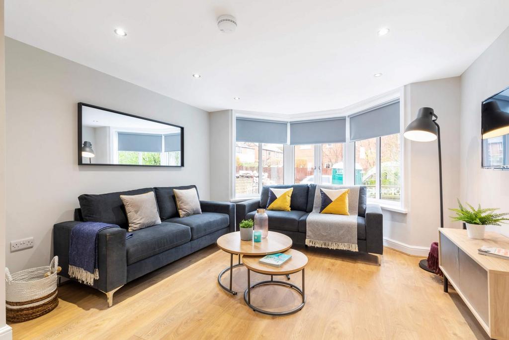 Bright, contemporary living room with bay windo...
