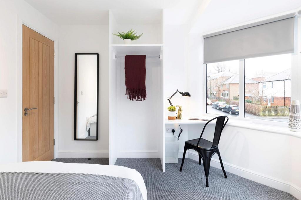 Bright, well-presented bedroom with a large win...