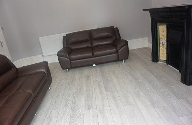Bright contemporary living room with light wood...