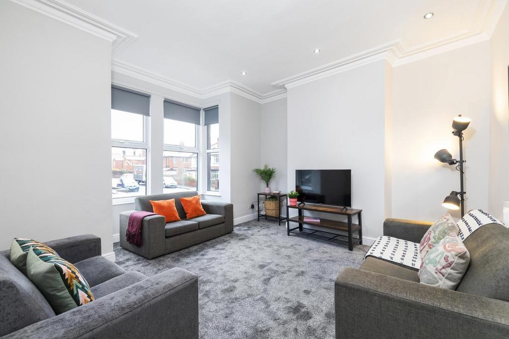 Bright, modern living room with large bay windo...