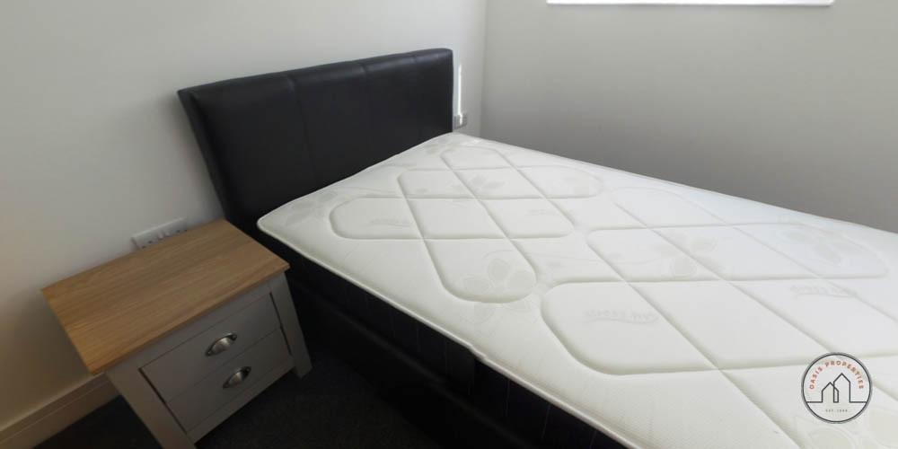 Neat single bedroom with a mattress on a modern...