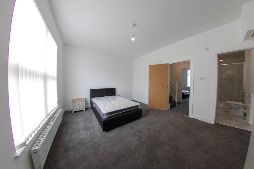 Bright, airy master bedroom with large window, ...