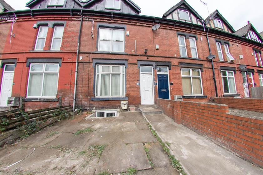 Red-brick terraced house with bay windows and a...