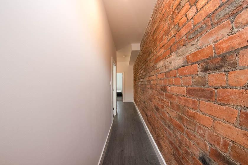 Bright, modern hallway with an attractive expos...