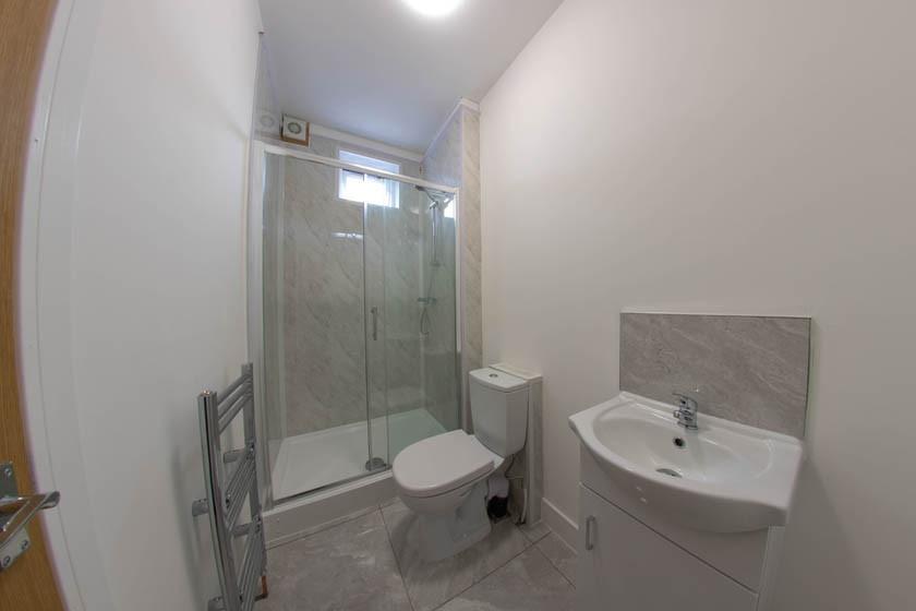 Bright, modern bathroom with a walk-in glass sh...