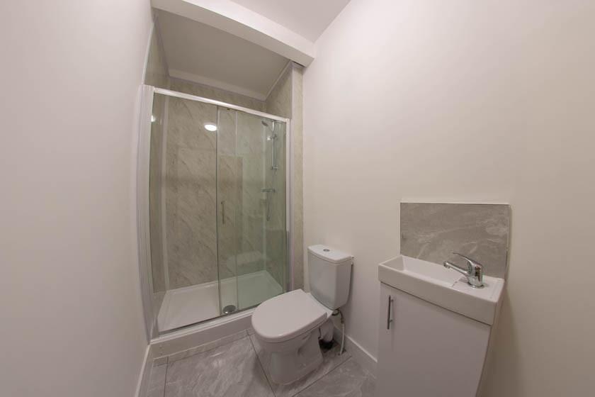Modern bathroom with a glass-enclosed shower, c...