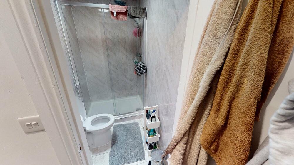 Modern bathroom with a walk-in shower, white to...