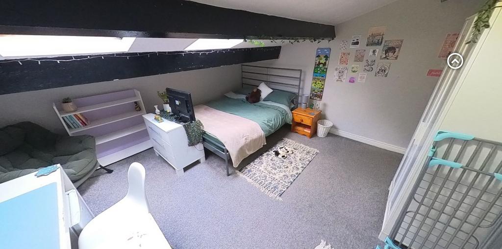 Bright, neatly kept bedroom with a comfortable ...