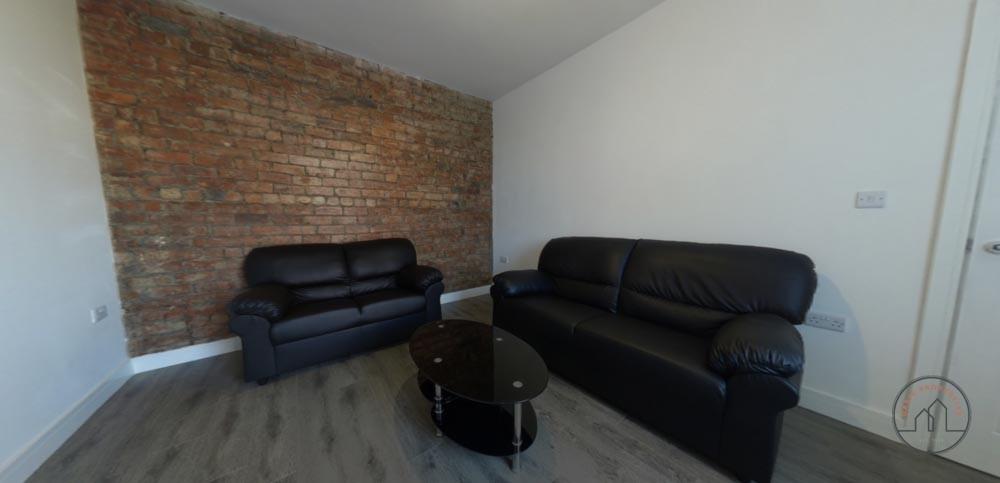 Contemporary living room with exposed brick acc...