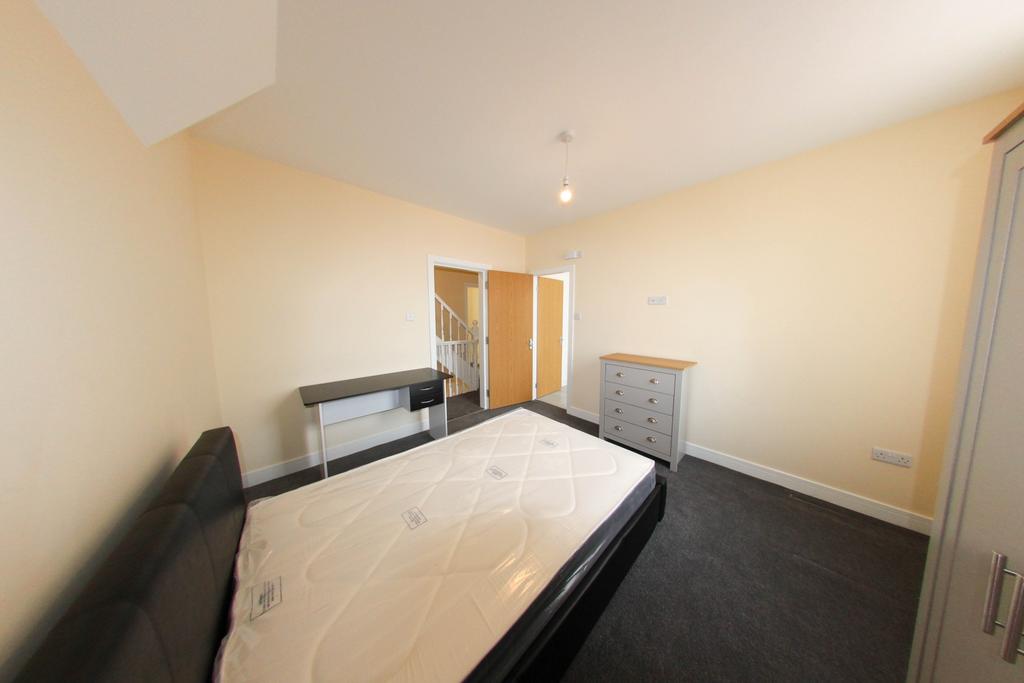 Bright, neutrally decorated double bedroom with...