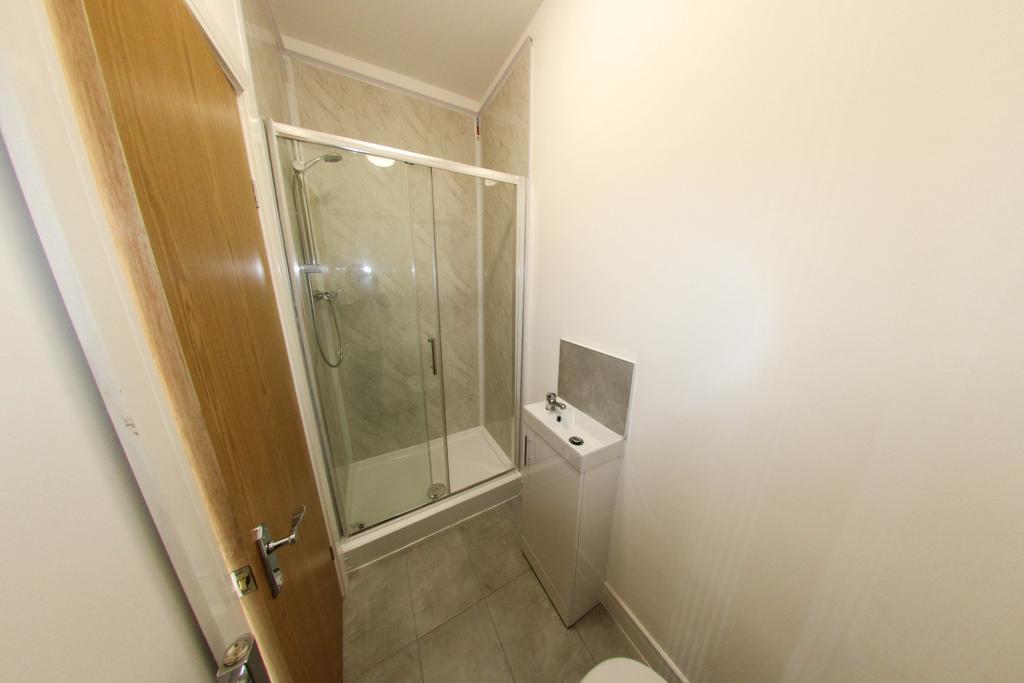 Bright, modern bathroom with a glass-enclosed s...