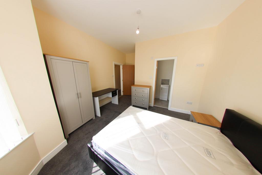 Bright, well-presented bedroom with a large win...