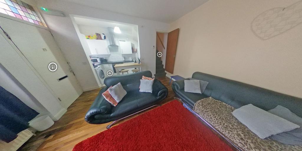 Bright, inviting living room with leather sofas...