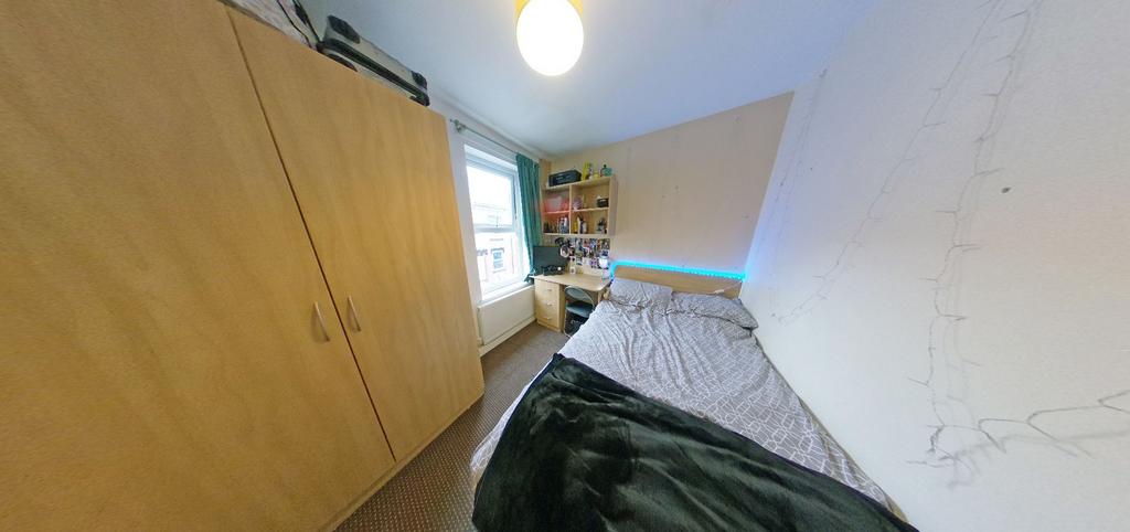 Cozy furnished bedroom with a comfortable singl...