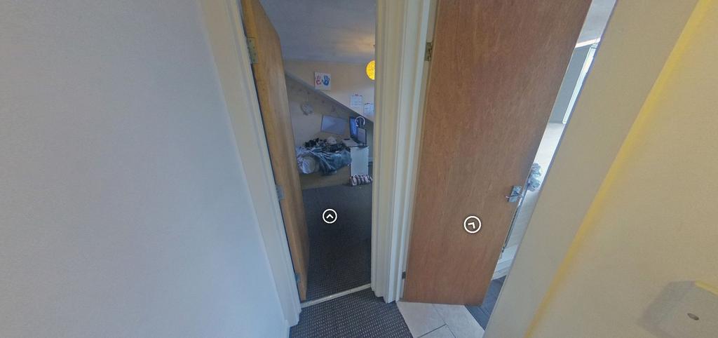 Narrow internal hallway with two open doors lea...