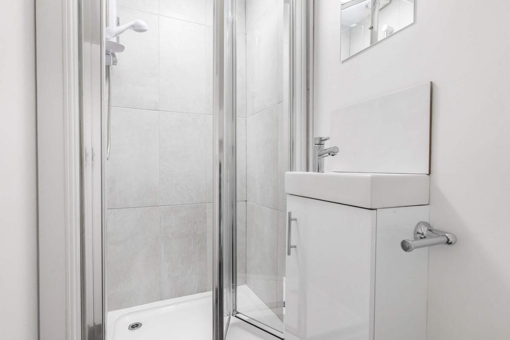 Bright, contemporary bathroom with a modern sho...