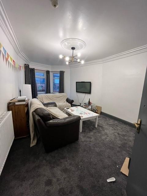 Comfortable communal living room with sofas, wa...