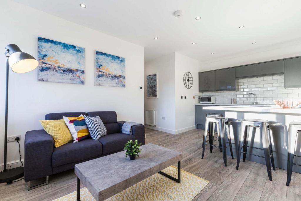 Bright, modern open-plan living area with a com...