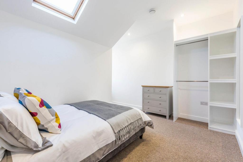 Bright, neatly presented bedroom with a comfort...