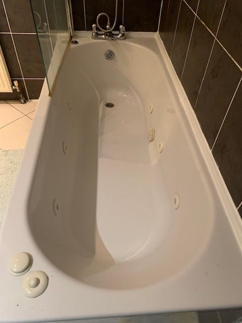 Well-maintained bathroom featuring a deep white...
