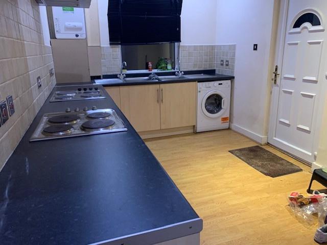 Long galley-style kitchen with a full-length co...