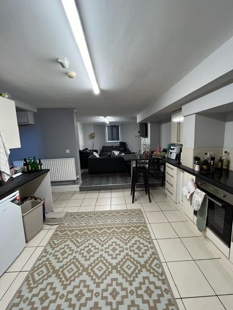 Open-plan lower-ground living space with a fitt...