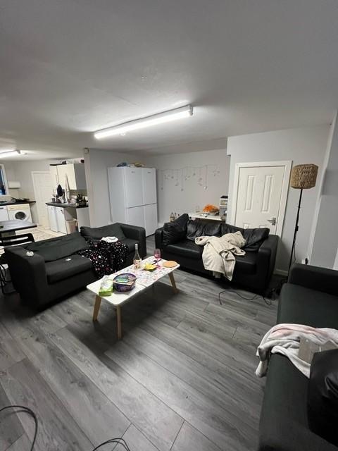 Contemporary communal lounge with multiple sofa...