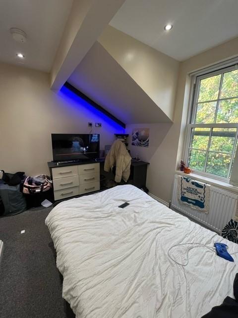 Bright attic-style double bedroom with a large ...