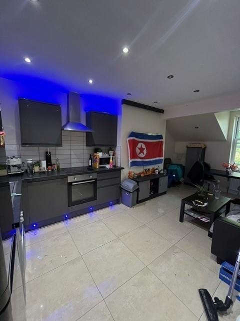 Contemporary open-plan kitchen with modern grey...