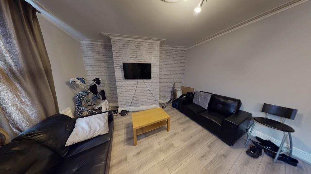 Contemporary living room with matching black le...