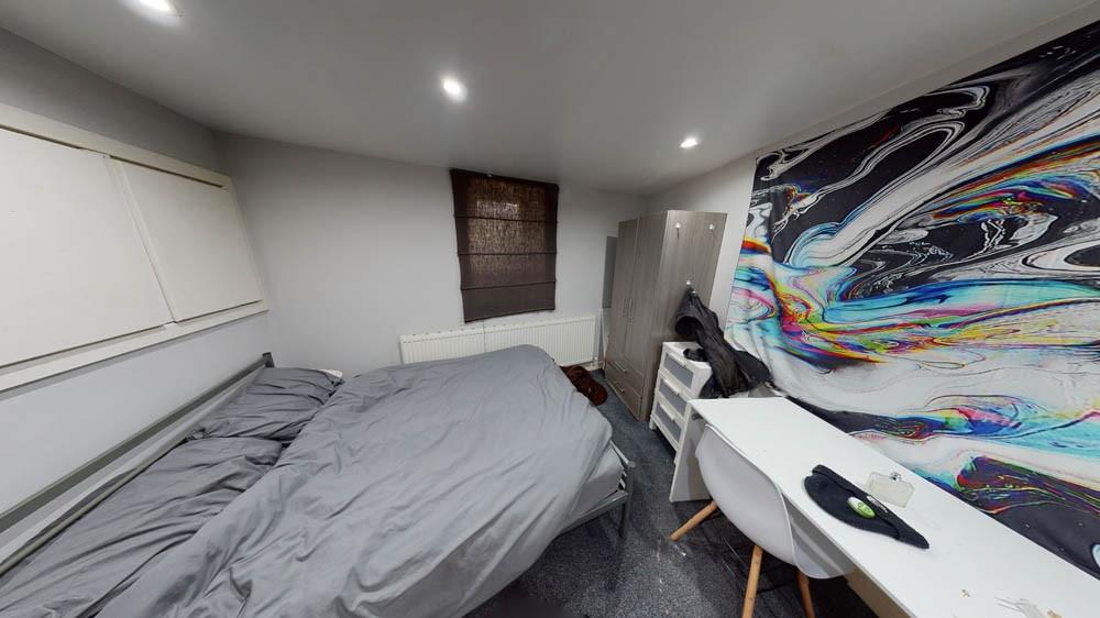 Bright, modern double bedroom with neutral deco...