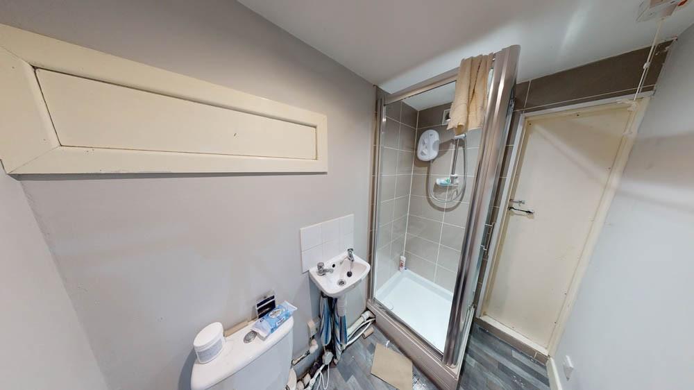 Modern bathroom with a glass-enclosed shower, p...