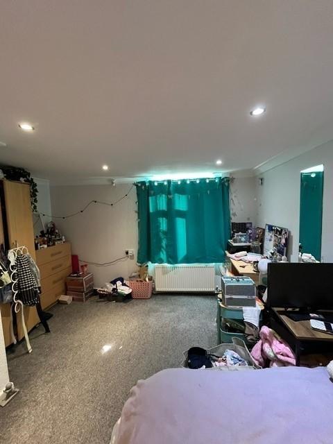 Bright, well-lit bedroom with carpeted floors, ...