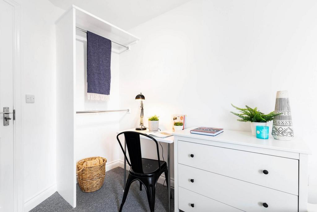 Bright, tidy bedroom corner with a smart study ...