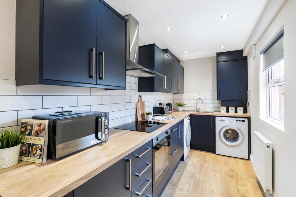 Bright, modern galley kitchen with plenty of st...