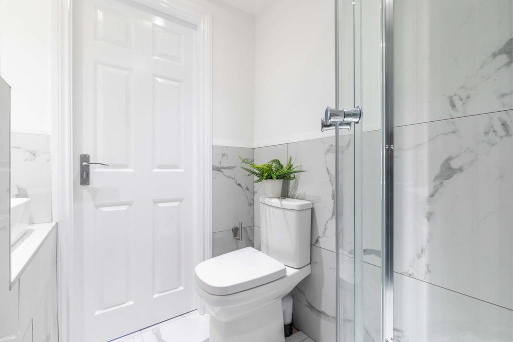 Bright, modern bathroom with a walk-in glass sh...